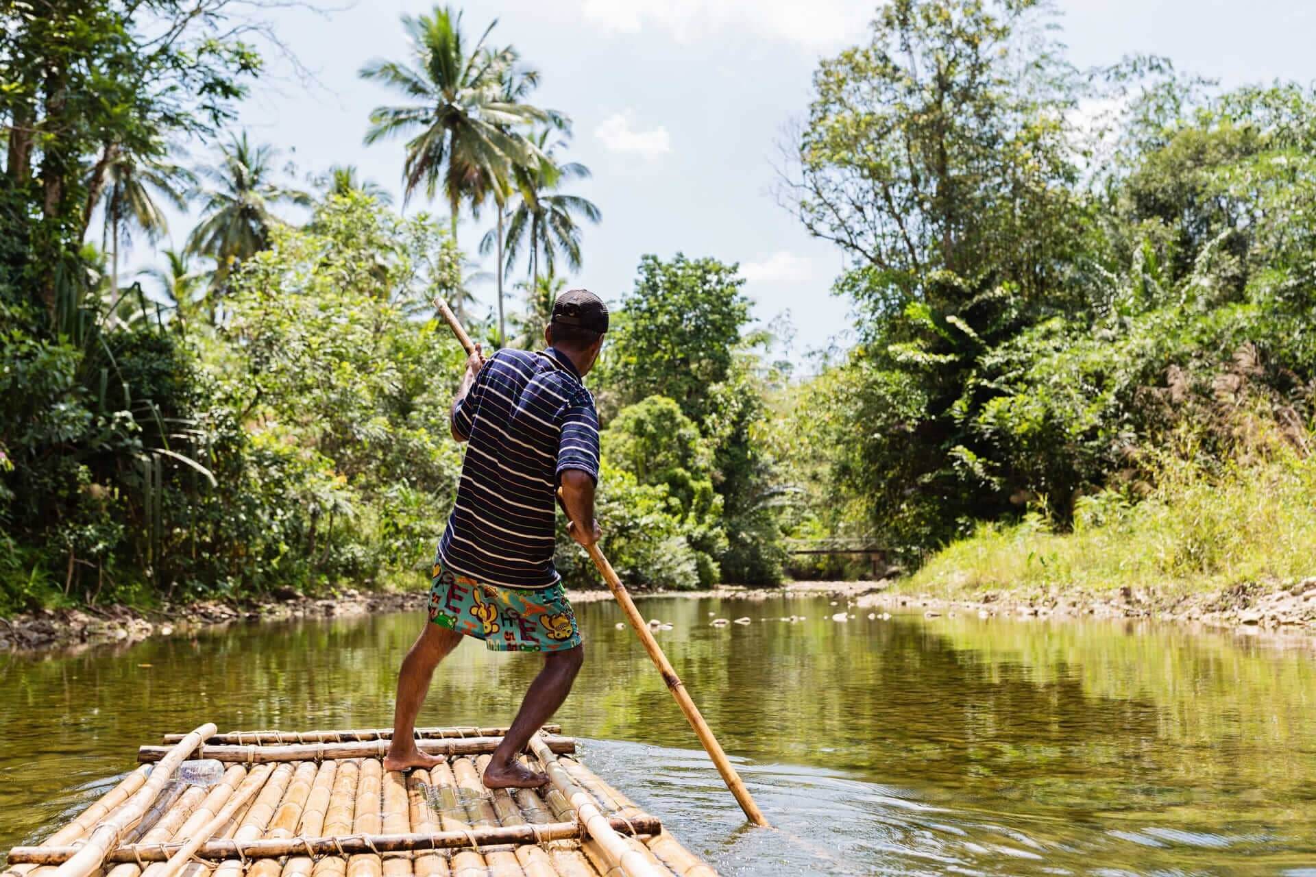 Man on bamboo raft in Jamaica